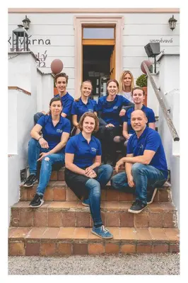 a group of people in blue shirts sitting on steps at Apartmány Malý mnich in Mníšek pod Brdy
