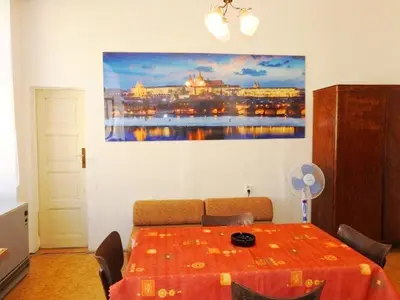 a room with a table and a painting on the wall at Apartment Havelska 10 in Prague