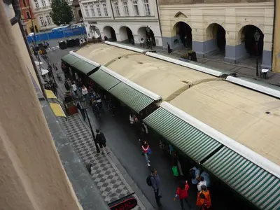 a group of people walking in a street with a building at Apartment Havelska 10 in Prague