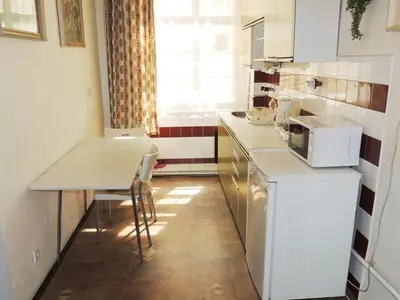 a small kitchen with a table and a microwave at Apartment Havelska 10 in Prague