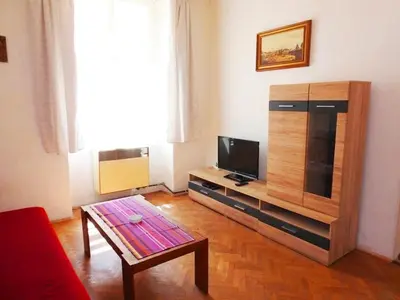 a living room with a tv and a coffee table at Apartment Havelska 10 in Prague