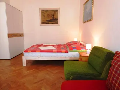 a bedroom with a bed and a couch and a chair at Apartment Havelska 10 in Prague