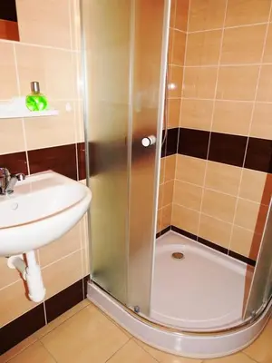 a shower with a sink and a toilet in a bathroom at Apartment Havelska 10 in Prague