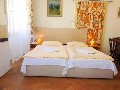 a bedroom with two beds and two lamps on tables at Apartment Havelska 10 in Prague