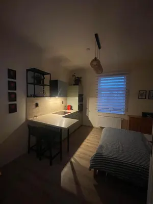 a kitchen with a counter and a desk in it at Apartmán Lucián in Prague