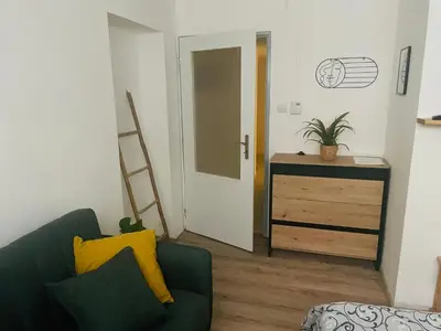 a bedroom with two beds and a painting on the wall at Apartmán Lucián in Prague