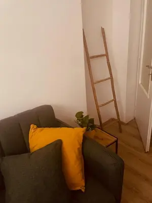 a bedroom with a bed and a tv on the wall at Apartmán Lucián in Prague