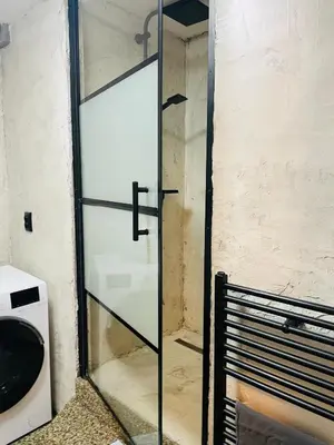 a bathroom with a toilet and a washing machine at Apartmán Lucián in Prague