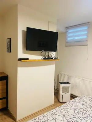 a living room with a dining room table and a door at Apartmán Lucián in Prague