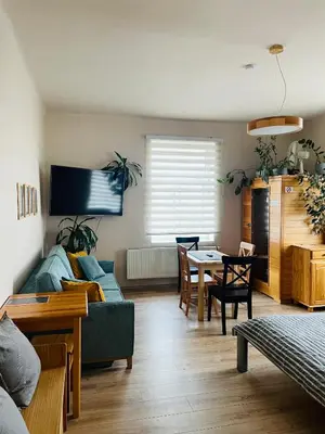 a living room with a bed and a dining room at Apartmán Lucián in Prague