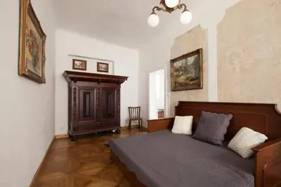 a bedroom with a bed and a cabinet in it at Old Town Apartment in Prague