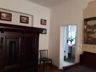 a room with a fireplace and a chair and a mirror at Old Town Apartment in Prague