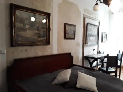 a bedroom with a bed and a picture on the wall at Old Town Apartment in Prague