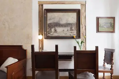 a room with two chairs and a picture on the wall at Old Town Apartment in Prague