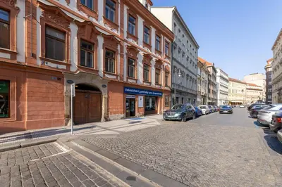 a city street with cars parked on the street at Old Town Apartment in Prague