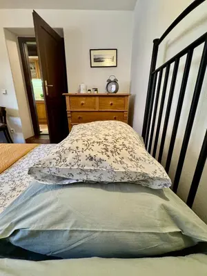 a bedroom with a bed with a pillow and a dresser at Apartmány Nerudova 36 in Prague