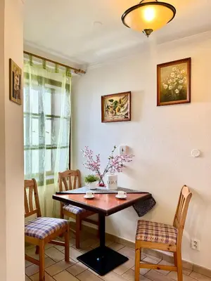 a dining room with a wooden table and chairs at Apartmány Nerudova 36 in Prague