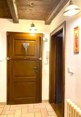 a wooden door in a hallway next to a room at Apartmány Nerudova 36 in Prague