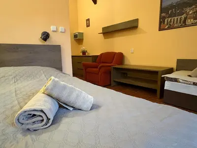 a bedroom with a bed with a towel on it at Penzion Na Hradbách in Louny