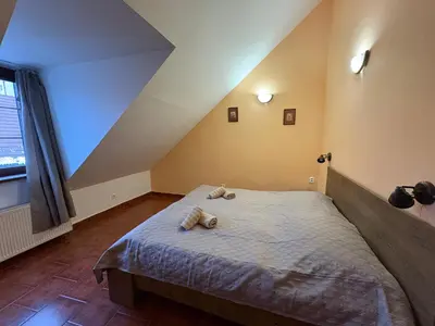 a bedroom with a bed with two teddy bears on it at Penzion Na Hradbách in Louny