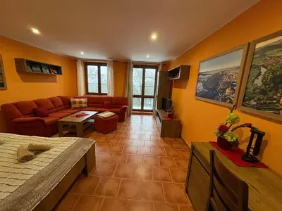 a living room with orange walls and a couch at Penzion Na Hradbách in Louny