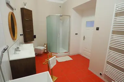 a bathroom with a shower and a sink and a toilet at Art Nouveau Apartment in Prague