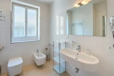 a white bathroom with a sink and a toilet at Old Town Square Apartments in Prague
