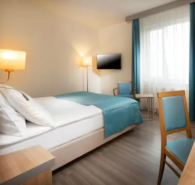 a hotel room with a bed and a tv at Holiday Inn Prague by IHG in Prague
