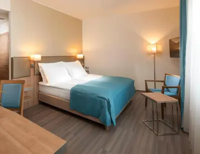 a hotel room with a bed and two chairs at Holiday Inn Prague by IHG in Prague
