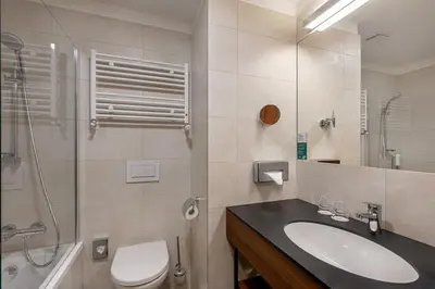 a bathroom with a sink and a toilet and a shower at Holiday Inn Prague by IHG in Prague