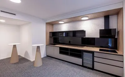 a room with a large television and two stools at Holiday Inn Prague by IHG in Prague