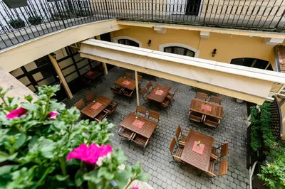 an overhead view of a patio with tables and chairs at Pension U Lilie in Prague