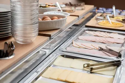 a buffet line with meats and cheese and eggs at Pension U Lilie in Prague