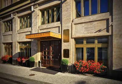 a facade of a building with flowers in front of it at Hotel Clement in Prague