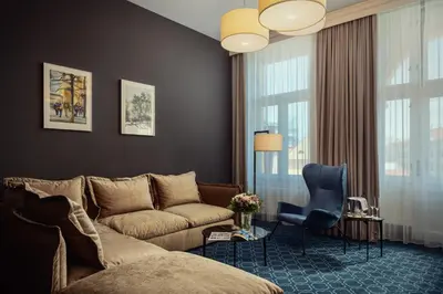 a living room with a couch and a chair at Hotel KINGS COURT in Prague