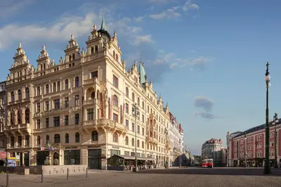 a large white building on a city street at Hotel KINGS COURT in Prague