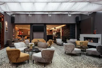 a lobby with couches and chairs and a television at Hotel KINGS COURT in Prague