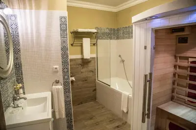 a bathroom with a tub and a sink and a shower at Amálka u Řípu in Straškov