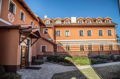a large orange building with a pathway in front of it at Amálka u Řípu in Straškov