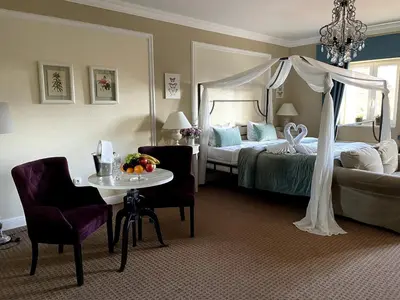 a hotel room with a bed and a table and chairs at Amálka u Řípu in Straškov