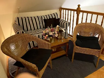 a living room with a couch and two chairs at Amálka u Řípu in Straškov