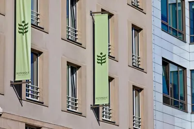 a building with green banners on the side of it at Botanique Hotel Prague in Prague