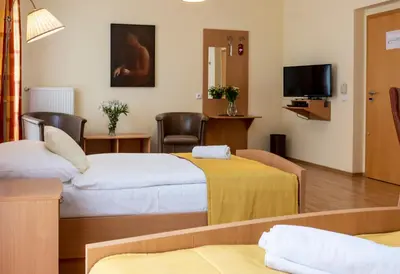 a hotel room with two beds and a tv at Pavilon in Ricany