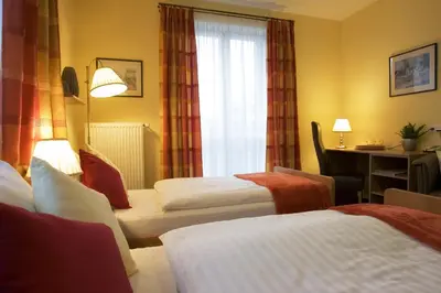 a hotel room with two beds and a desk at Pavilon in Ricany