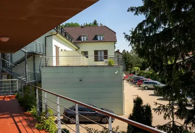 a building with cars parked in a parking lot at Pavilon in Ricany