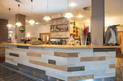a bar with a counter made out of wood at Pavilon in Ricany