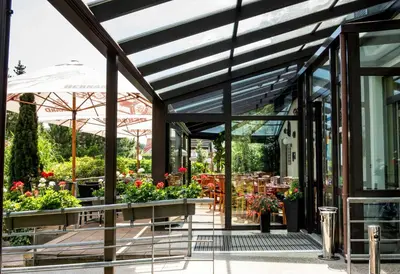 a garden shop with glass doors and flowers at Pavilon in Ricany