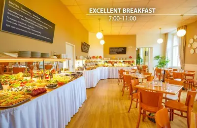 a restaurant with a buffet of food on display at Metropolitan Old Town Hotel - Czech Leading Hotels in Prague