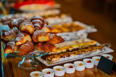 a display of pastries and other pastries on a table at Metropolitan Old Town Hotel - Czech Leading Hotels in Prague