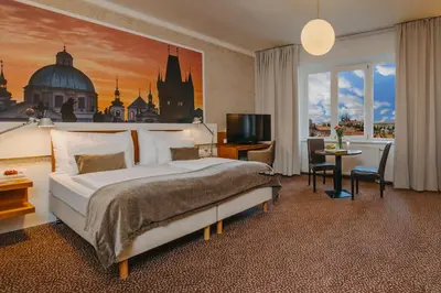 a hotel room with a bed and a large window at Metropolitan Old Town Hotel - Czech Leading Hotels in Prague